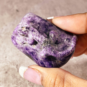 Charoite lizard carving